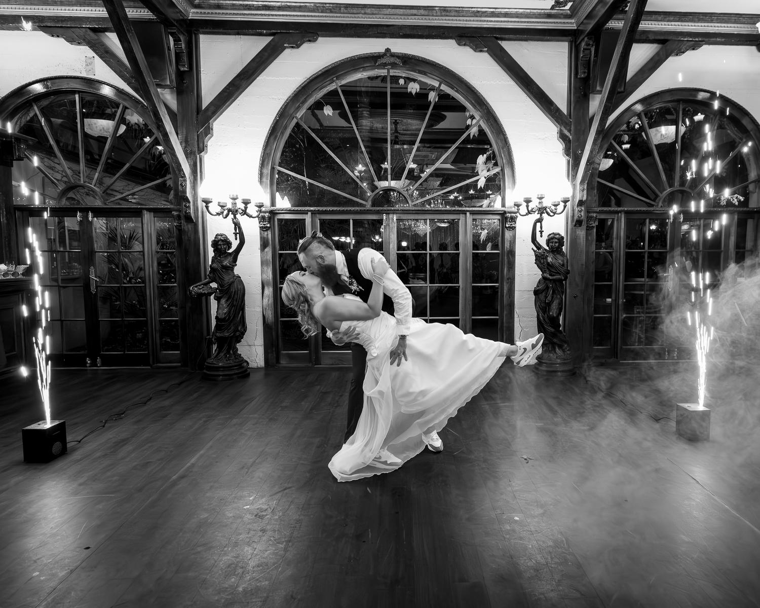 Black and white photo of Ronan dipping Felicity during their first dance