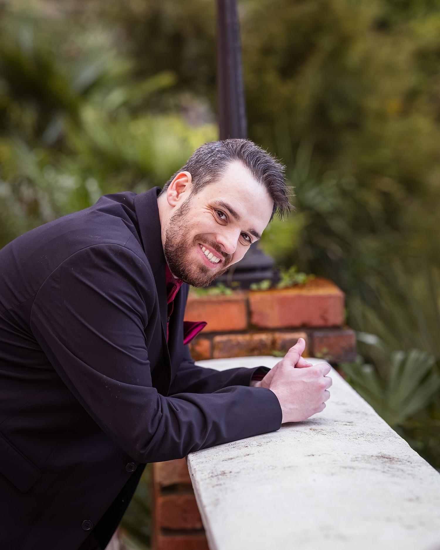 A man in a suit is smiling at the camera