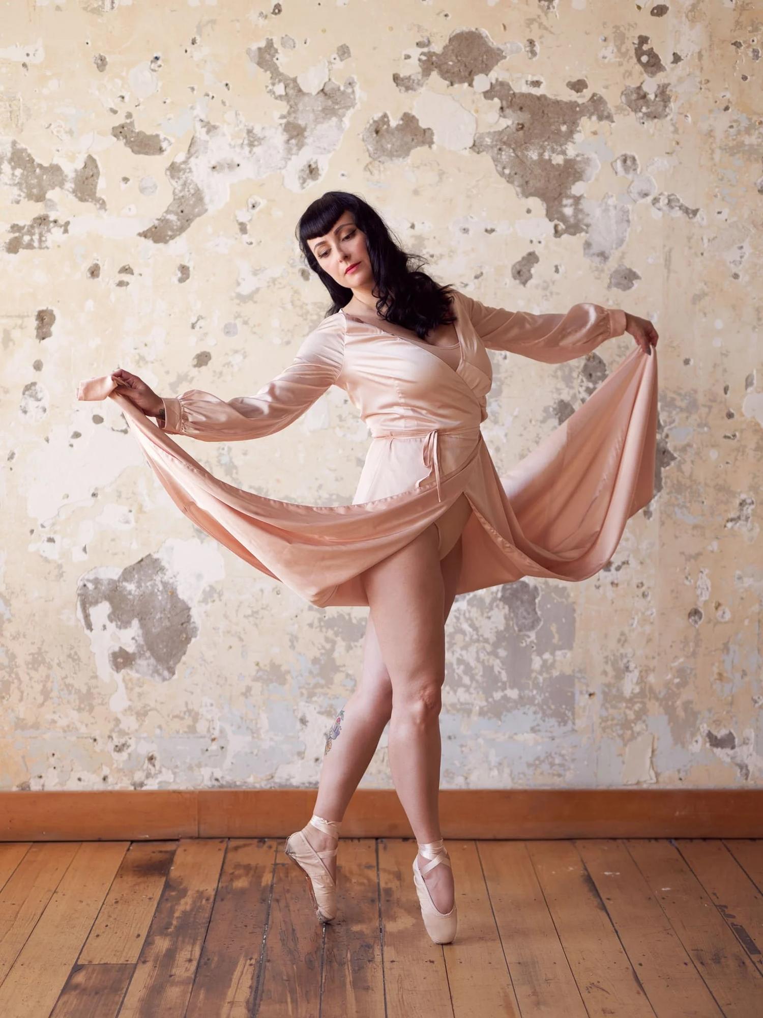 Viv lifts her skirt and stands on pointe