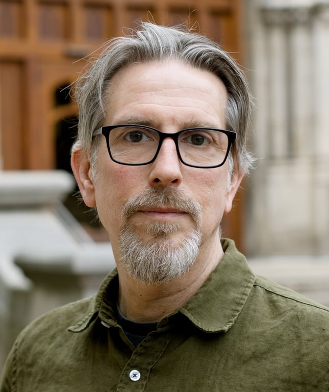 An image of a man wearing glasses, facing the camera