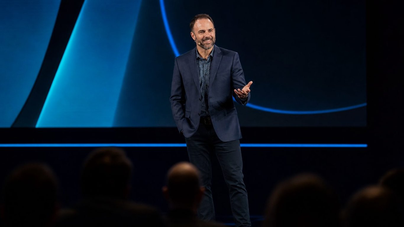 Brad Costanzo speaking on stage at a keynote