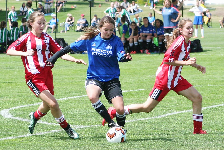 <who>Photo Credit: Contributed </who>Ashlyn Eisenkrein, left, and Madison Dyck, right, defend against Penticton in a TOYSL semifinal match.