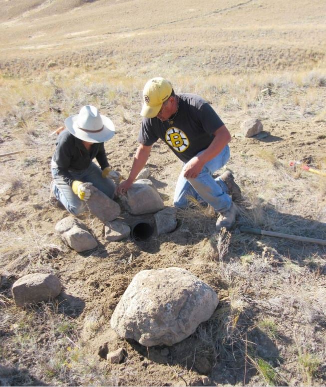<who> Photo Credit: Chris Gill </who> Dawn Brodie of the Burrowing Owl Conservation Society of BC and Upper Nicola Band technician Cliff Chillihitzia prepare the first burrow entrance.