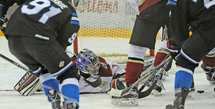 <who>Photo Credit: Lorne White/KelownaNow.com </who>Matthew Greenfield sprawls to grab a loose puck in the second period of the Warriors 2-1 win at Royal LePage Place.