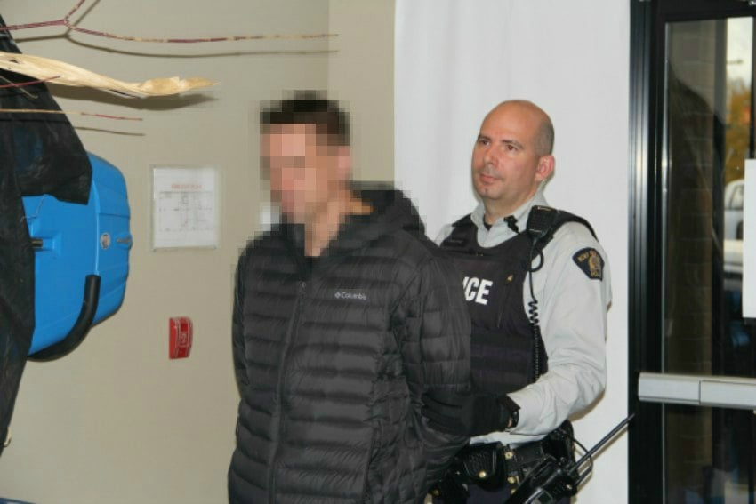 <who> image Credit: KelownaNow </who> The 34-year-old man arrested in the KelownaNow office, whose identity has been obscured, moments before RCMP took him away