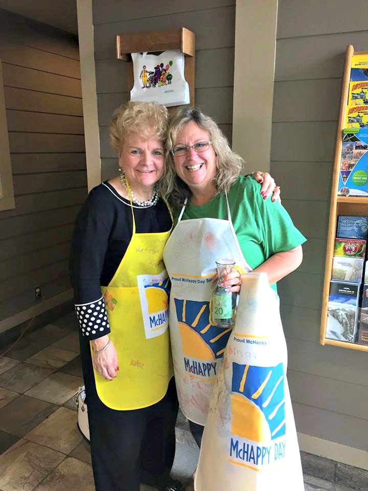 <who> Photo Credit: KelownaNow. </who> Kelowna City Councillor Maxine Dehart with volunteer Reagan Krivsky at McHappy Day in Kelowna, 2015.