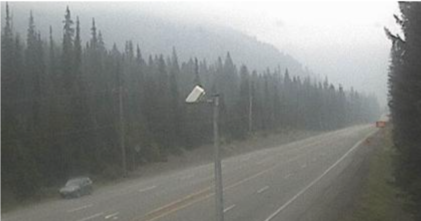 <who> Photo Credit: BC Highway Cameras </who> Heavy smoke can be seen along Highway 3 at Allison Pass.