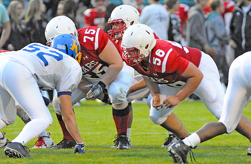 <who>Photo Credit: Lorne White/KelownaNow </who>Wyatt Fagan (56) among the Boucherie defensive stalwarts in Wenatchee.