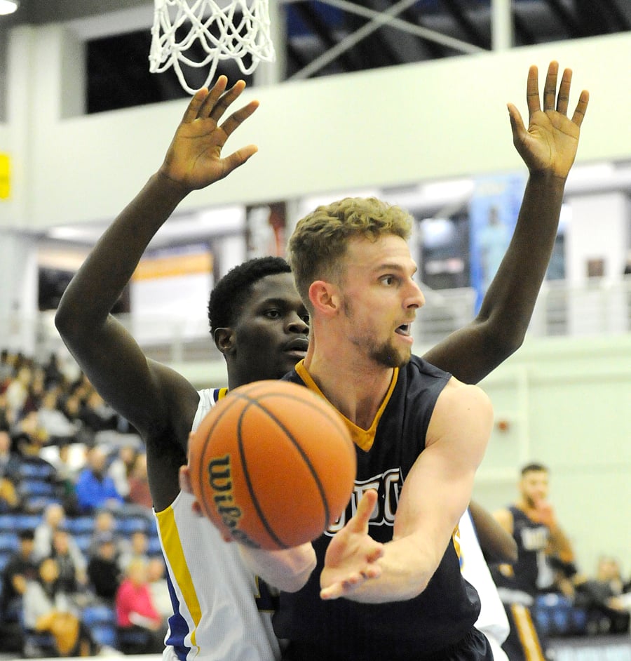 UBC's Grant Shephard receives a pass in front of UBCO Heat's Imoudu Ibrahim.