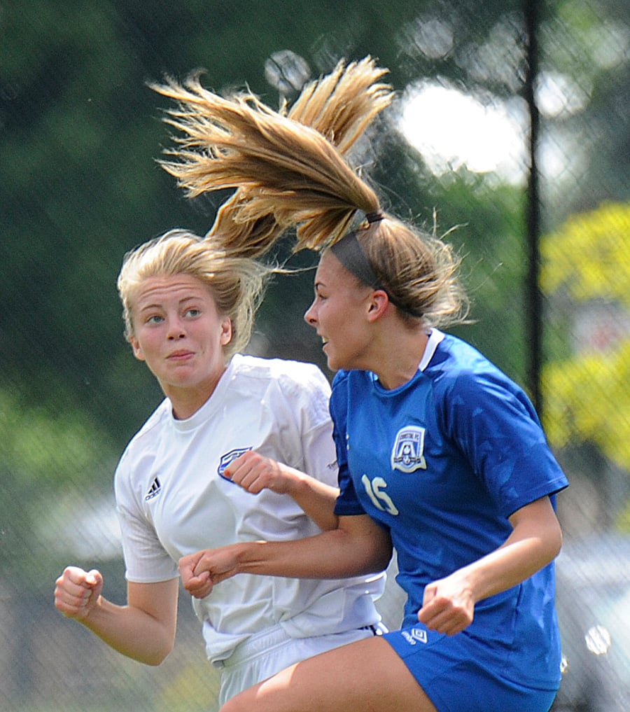 <who>Photo Credit: Lorne White/KelownaNow </who> Jaidyn McGrath, left, of TOFC battled in the air with a Coastal FC forward.
