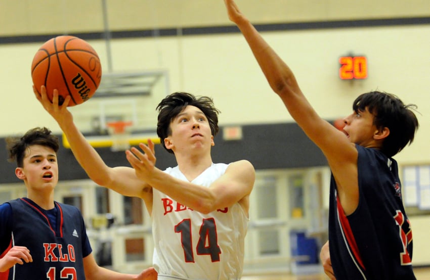 <who>Photo Credit: Lorne White/KelownaNow </who>Sam Dixon of the Mt. Bcucherie Bears splits the KLO Cougars' defence for two points in semifinal play.
