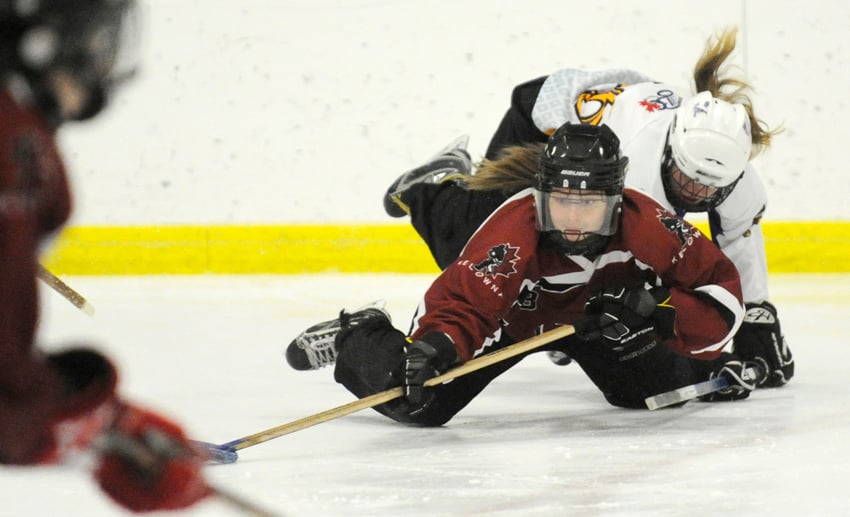 <who>Photo Credit: Lorne White/KelownaNow </who>Nigella Russel shows her tenacity by keeping possession of the ring while being checked from behind by a Vernon Impact in the provincial U16A championship game on Sunday at the Rutland Arena.