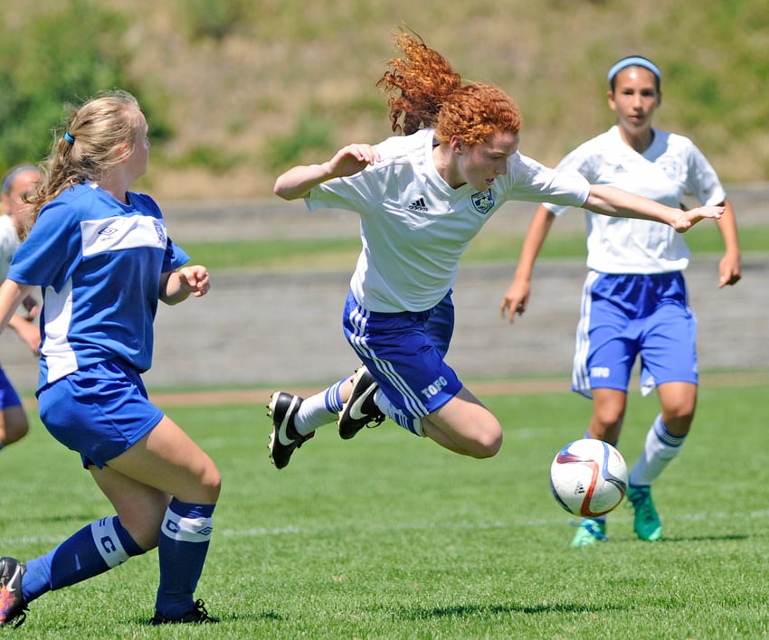 <who>Lorne White/KelownaNow </who>TOFC's Kiera Howaniec is tripped up while bringing the ball up the wing in the first half of the U13 Premier Cup final.
