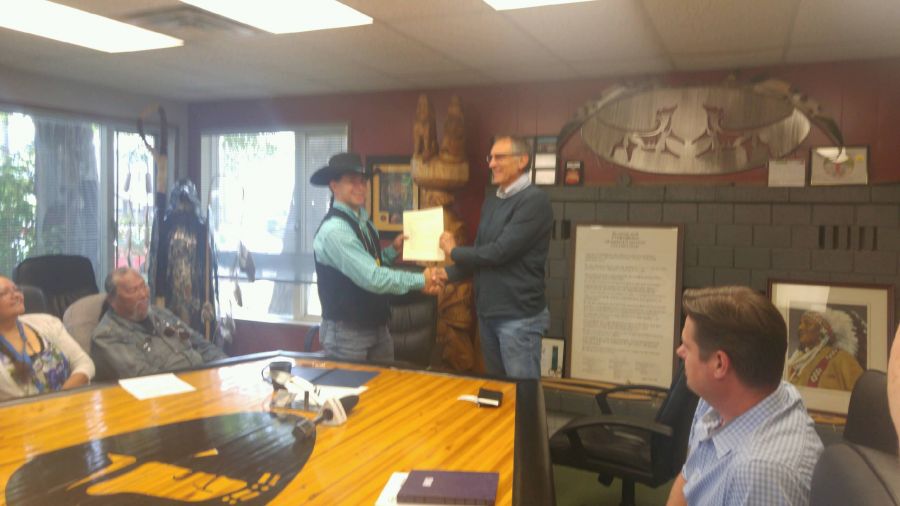 <who>Photo Credit: PentictonNow </who>Penticton Indian Band Chief Chad Eneas and Interfor vice-president Rick Slaco hold up the official Memorandum of Understanding they signed Wednesday morning at the PIB council boardroom.