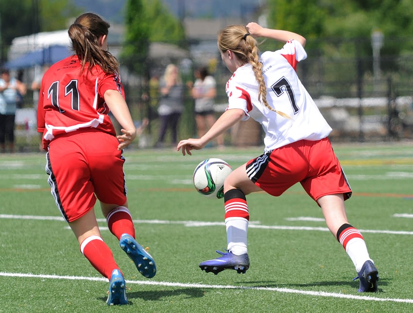 <who>Photo Credit: Lorne White/KelownaNow </who>United U15s' Kelly McCombie, left, defends against United U16s' Ashley Kimler in their TOYSL match at Mission Stadium.
