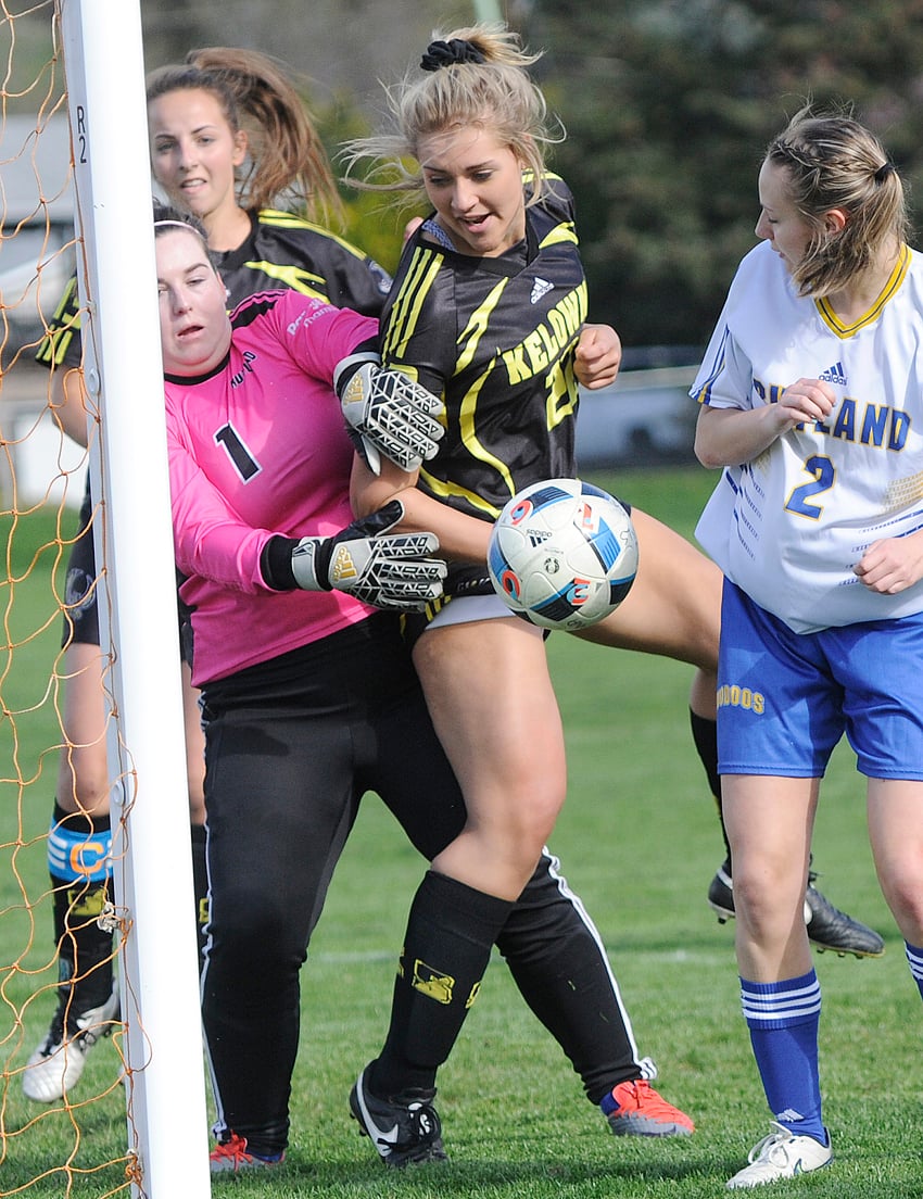 <who>Photo Credit: Lorne White/KelownaNow </who>Kate Armitage, left, of the Rutland Voodoos makes a save on deflection by the Kelowna Owls' Fiona Reha off a corner kick during their Okanagan Valley senior AAA soccer league match this week. To the right is Rutland's Courtney Blacklaws while Rene Watson of the Owls is in the background.