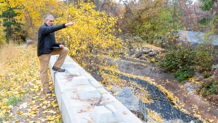 <who>Photo Credit: NowMedia/Gord Goble</who> Peter Mortifee on a flood control barrier above flume/channel