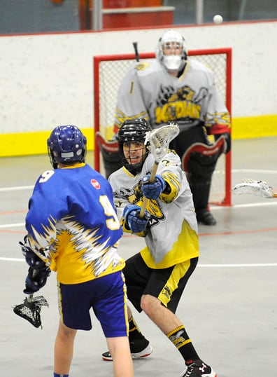 <who>Lorne White/KelownaNow </who>Oliver DiMarcello of the Kelowna Kodiaks tries to defend against <br>a Kamloops Rattler who gets a shot on netminder Joe Prohaska.