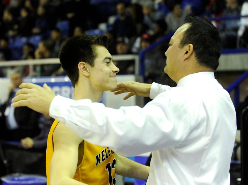 <who>Photo Credit: Lorne White/KelownaNow.com </who>Mason Bourcier and Kelowna Owls' coach Harry Parmar share a special moment seconds before the final buzzer.