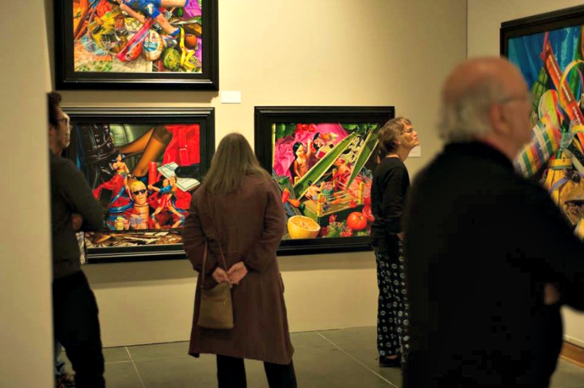 Gallery goers take in pieces by Hall at his opening on Friday.