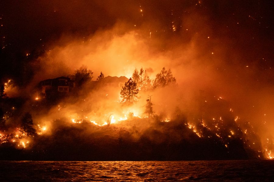 <who>Photo Credit: NowMedia/Nick Csek</who>A home burns in Traders Cove, just north of West Kelowna, during the McDougall Creek wildfire in August 2023.