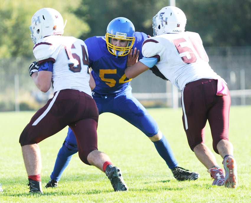 The Voodoos' Jared Pimiskern takes on two Griffins at the offensive line.