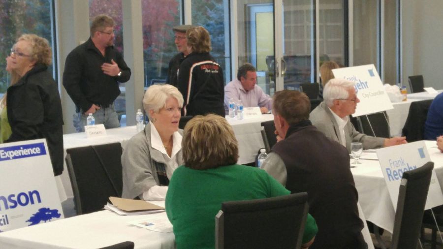 Former Penticton councillor Katie Robinson is shown talking to local residents face-to-face at Tuesday's candidates trade show.