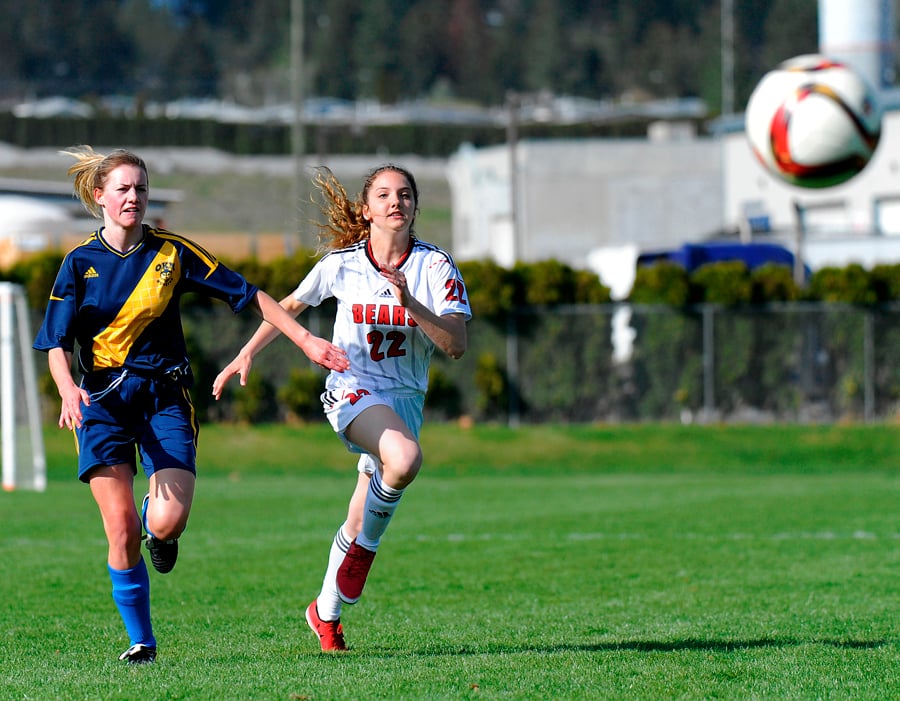 Lili Young, right, of Boucherie and the Huskies' Paige Payer follows up on a Bears shot on net