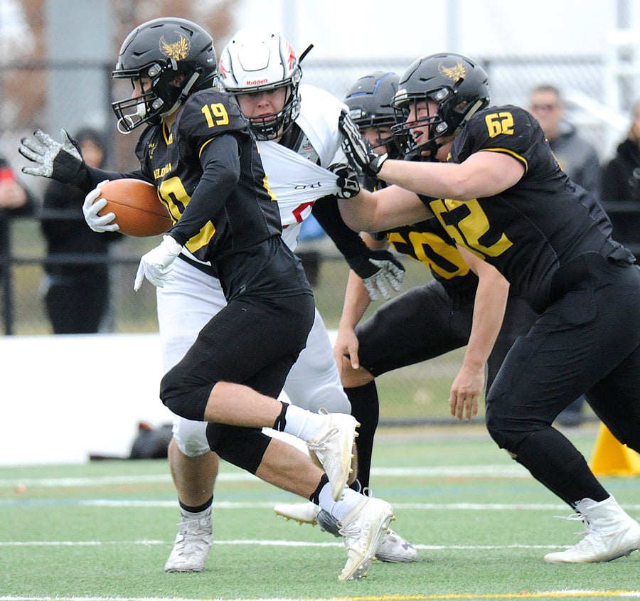 <who>Photo Credit: Lorne White/KelownaNow </who>Running back Noah Cross (19) will be relying on the Owls' offensive line, including Jack Marsland (52) to make room for what he does best.