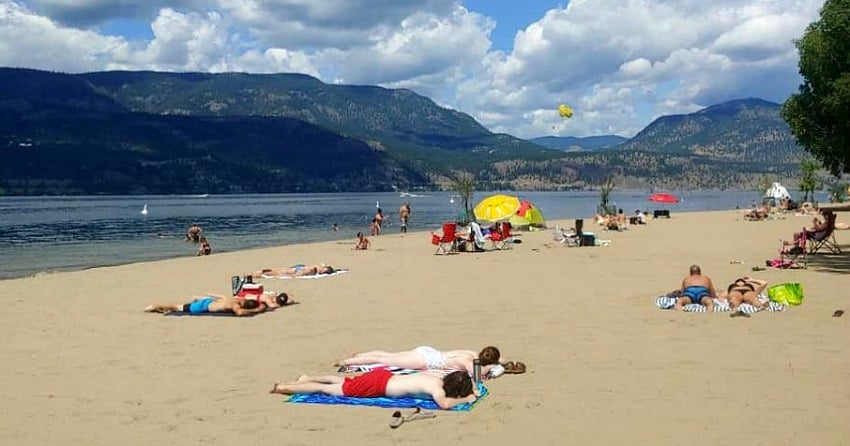 <who>Photo Credit: Instagram</who>People physical distancing on a Kelowna beach.