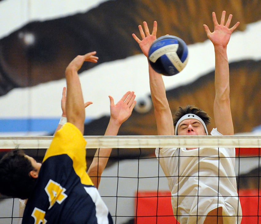 <who>Photo Credit: Lorne White/KelownaNow </who>Tournament all-star, Tommy Parish of the Coyotes, blocks a MEI hit in a semifinal match.