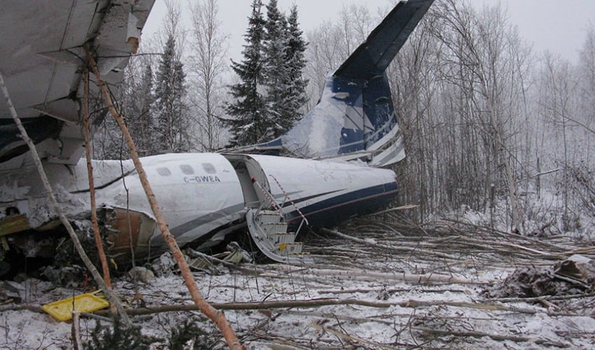 <who> Photo Credit: Transportation Safety Board </who> Left side view - back of aircraft wreckage showing aft left passenger door.