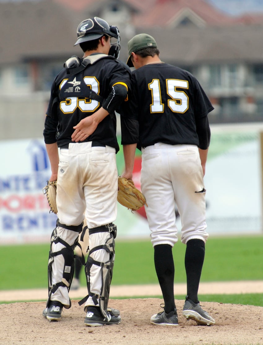 <who>Photo Credit: Lorne White/KelownaNow </who>A's catcher Marcus Strother and pitcher Cole Van Every meet on the mound in Saturday's opener at Elks.