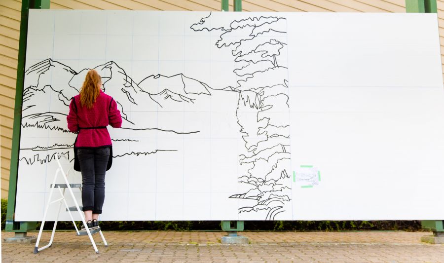 <who>Photo Credit: NowMedia</who> Rebecca Britton draws the outline of the exhibit's interactive paint-by-numbers mural.