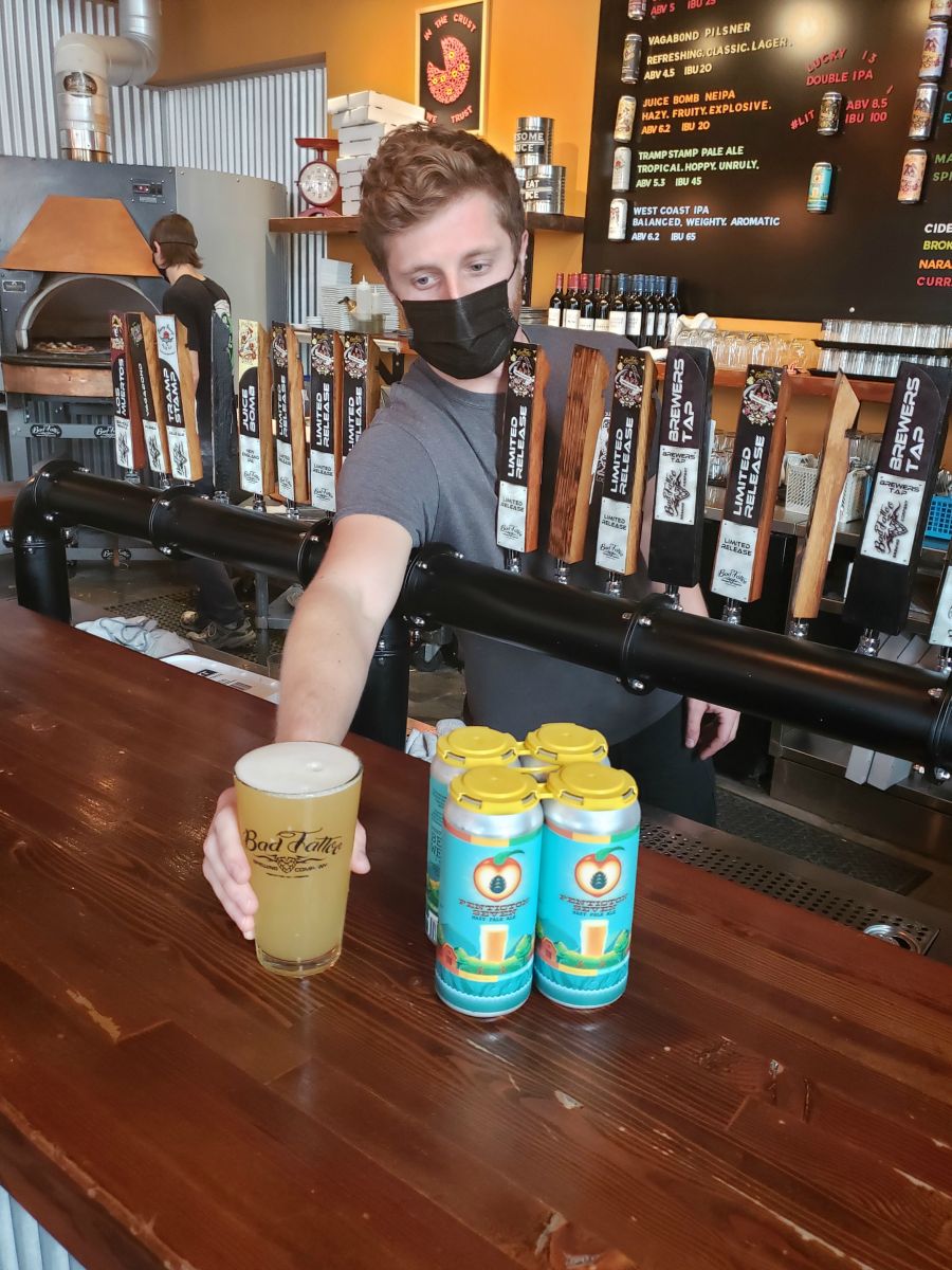 <who> Photo Credit: NowMedia </who> Bad Tattoo head brewer Liam Hutcheson serves up a Hazy Pale Ale.