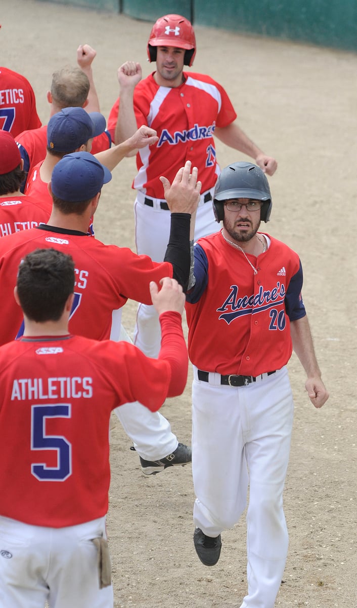 <who>Photo Credit: Lorne White/KelownaNow </who>Aaron Bacon, foreground, and Derek Como receive high-fives after Bacon's home run against Grande Prairie.