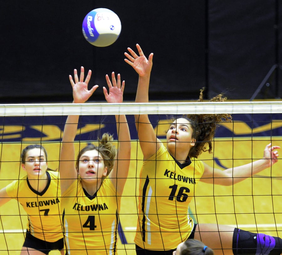 Lexi Prefontaine, middle, and Anya Pemberton, right, block against Handsworth. Sophie Lachapelle is on the left.