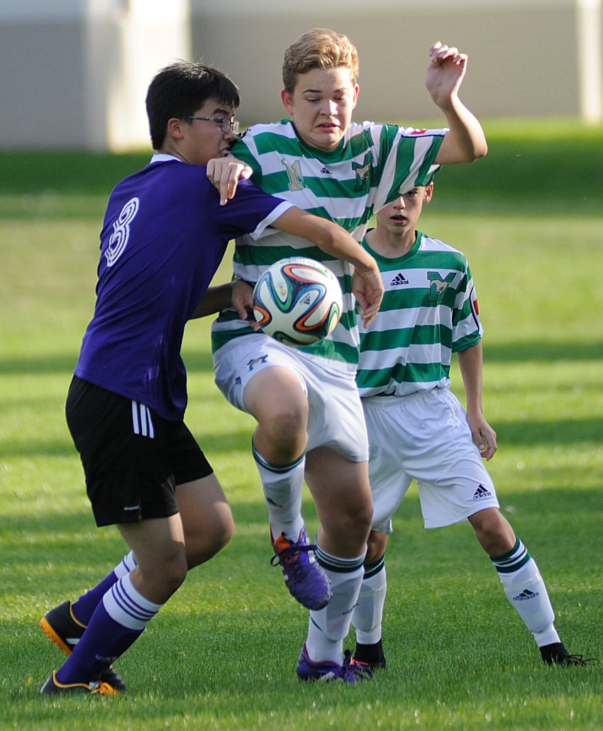 <who>Photo Credit: Lorne White/KelownaNow </who>The Mustangs' Jayden Podmoroff battles for possession with the KCS Knights' Ken Haung, left, in the first half of their Central Okanagan senior A soccer league game this week at Kelowna Christian School.