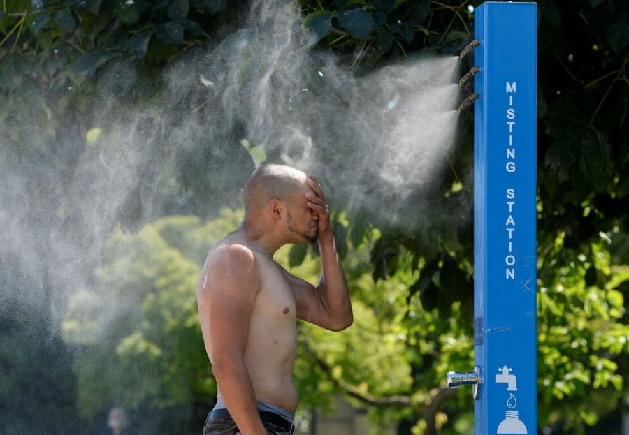 </who>The New York Times used this photo of a man cooling off at a misting station in Vancouver to illustrate its article on BC's heatwave.