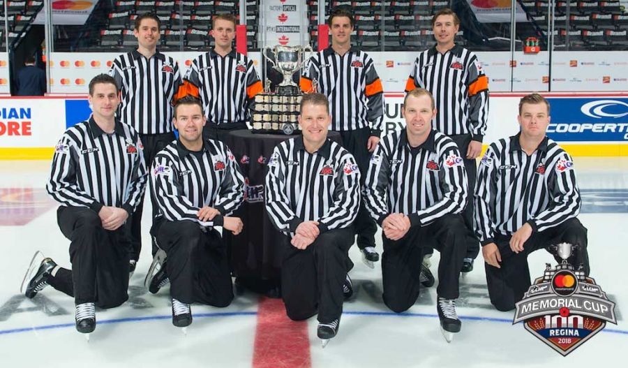 <who> Photo Credit: CHL</who> Steve Papp at the 2018 Memorial Cup in the back row and directly beside trophy on the right hand side