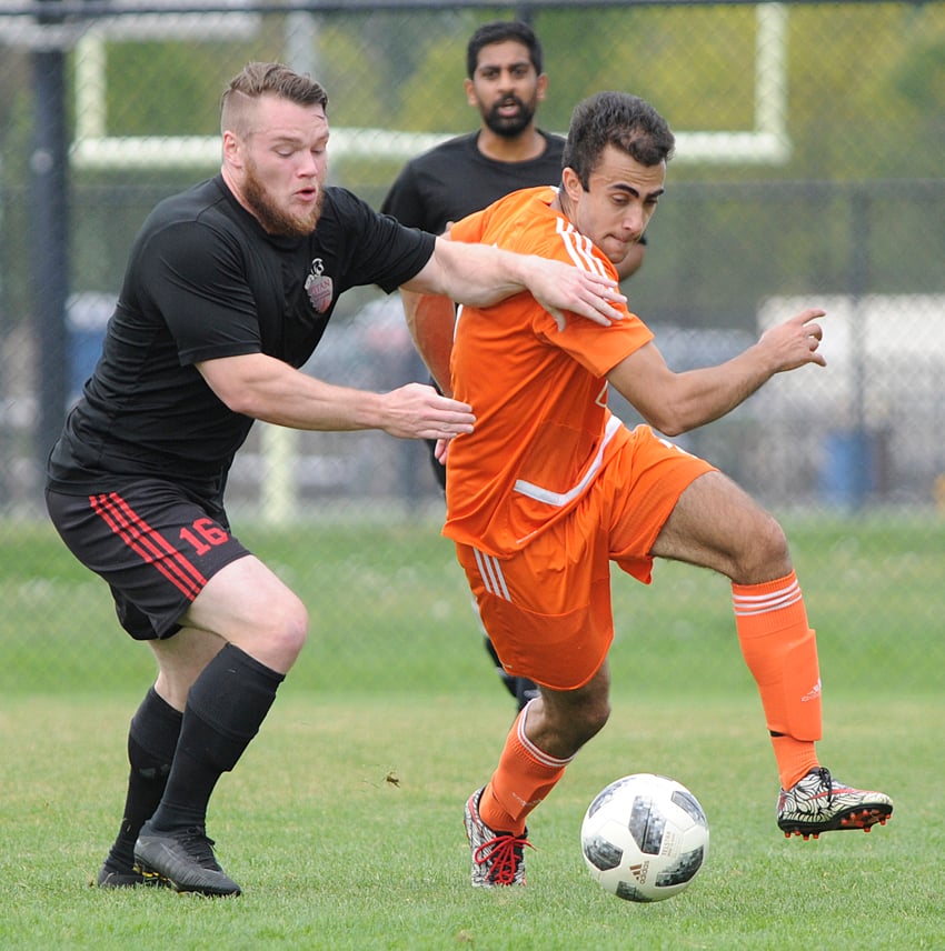 <who>Photo Credit: Lorne White/KelownaNow </who> Titan Celtic's Tristain Moench, left, battling with Form and Finish's Arvin Nikseresht, scored the winning goal in the KMSL Division 2 final.
