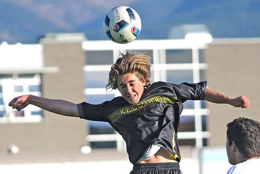 <who>Photo Credit: Lorne White/KelownaNow </who>Gregor Smith of the KSS Owls heads the ball in the 18-yard box during the first half of their 2-0 win over Salmon Arm.
