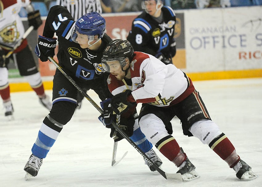 <who>Photo Credit: Lorne White/KelownaNow.com </who>Brett Mennear of the Warriors and Kelowna's Griffin Mendel of the Vees battle for position in front of the Penticton net in the second period.