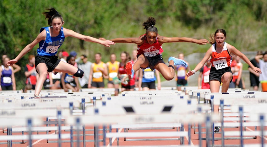 <who>Photo Credit: Lorne White/KelownaNow </who>Elayna Glen, left, of the Const. Neil Bruce Cubs won the Grade 8 80-metre hurdles and added a first-place finish in the triple jump. Mekhila Brown, centre, finished second in this race. On the right is Aberdeen's Tess Peacock.