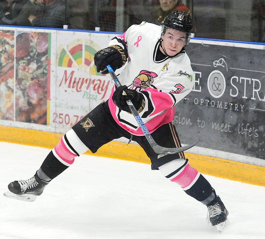 <who>Photo Credit: Lorne White/KelownaNow </who>Warriors' defenceman Jake Harrison clears the puck out of the West Kelowna zone during a Penticton Vees powerplay in the first period. The Warriors wore new jerseys on Saturday in honour of Breast Cancer Awareness.