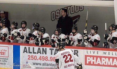 <who> Photo Credit: Jen Jensen </who> Carter Rigby behind the Coyotes bench.