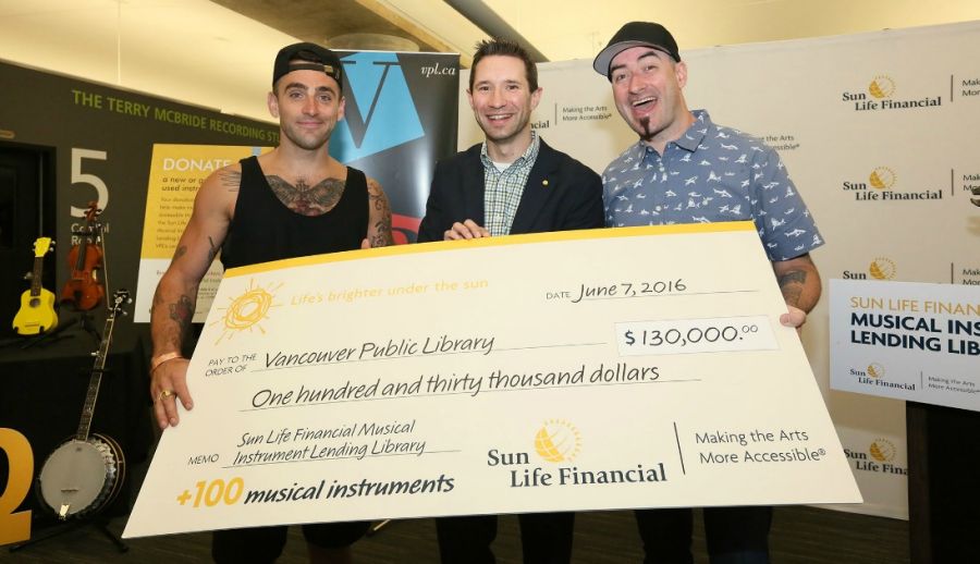 <who> Photo Credit: Sun Life Financial Canada </who> Hedley's Jacob Hoggard and Tommy Mac help to kick off the Sun Life Financial Musical Instrument Lending Library in Vancouver, BC. 