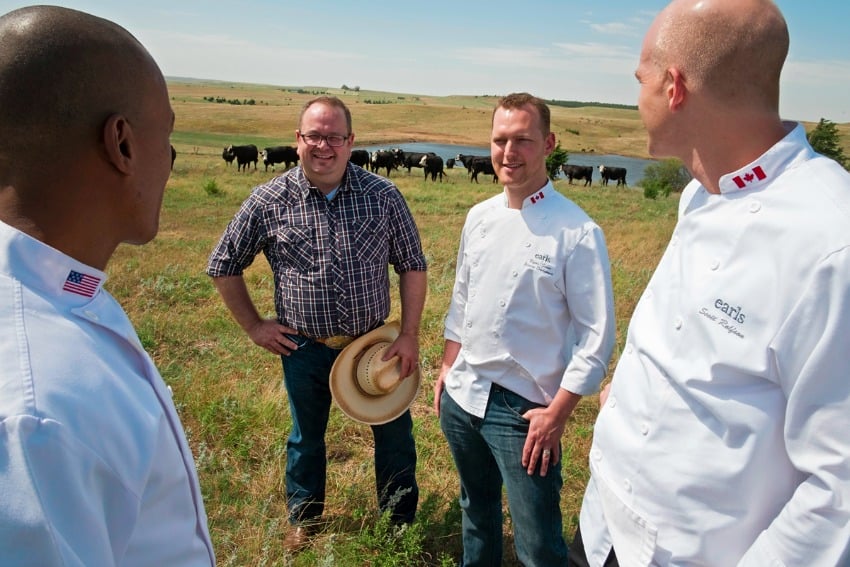 <who> Photo Credit: Earls Restaurants. </who> Earls chef's Ryan Stone, Scott Rolfson and Del Diseko with Earls meat buyer Dave Bursey at Creekstone Ranch.
