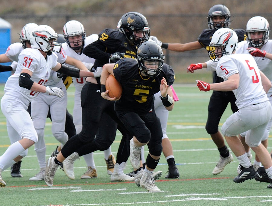 <who>Photo Credit: Lorne White/KelownaNow </who>Quarterback Nate Beauchemin breaks through the line on the way to a second-quarter touchdown.