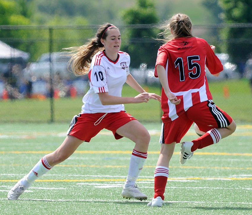 <who>Photo Credit: Lorne White/KelownaNow </who>United 15s' Tiernan Hickson, right, cradles the ball while U16s' Logan Finley moves into defend.